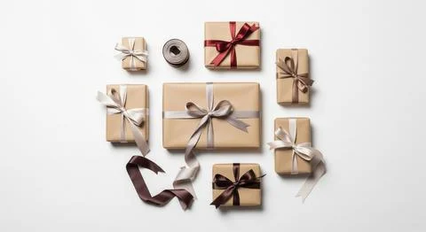 Elegant assortment of beige gift boxes tied with satin ribbons in warm neutral Stock Illustration