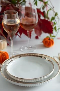 Elegant Autumn Table Setting with Wine Glasses and Decorative Pumpkins Stock Photos