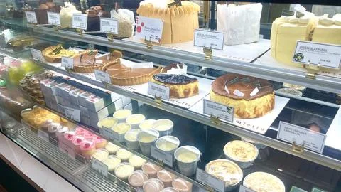 Elegant Bakery Display Showcasing Assorted Cakes and Pastries in a Glass Counter Stock Photos