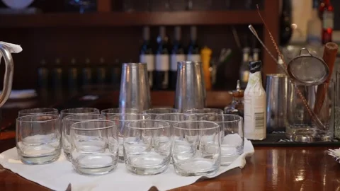An Elegant Bar Setup featuring Glasses, Various Mixology Tools, and a Chic Stock Footage 316511839