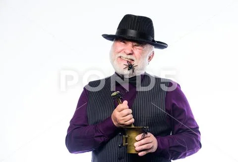 Elegant bartender wear hat and vest prepare drink. Horror party. Frightening Stock Photos
