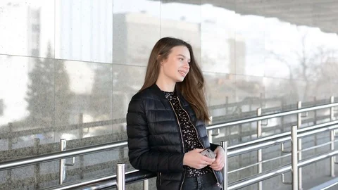 Elegant beautiful woman texting on smartphone in the city Stock Footage