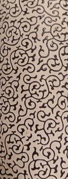 Elegant Black Floral Scroll Pattern on Beige Fabric Texture Stock Photos