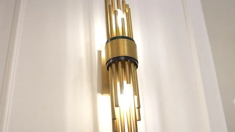 An Elegant Brass Wall Sconce Featuring a Stylish and Modern Design 库存影片 294161149