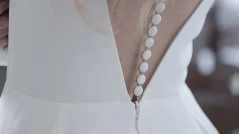 Elegant bride back with small white buttons of wedding dress Stock Footage 132700878