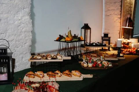 Elegant buffet display featuring assorted appetizers and desserts on wood Photos