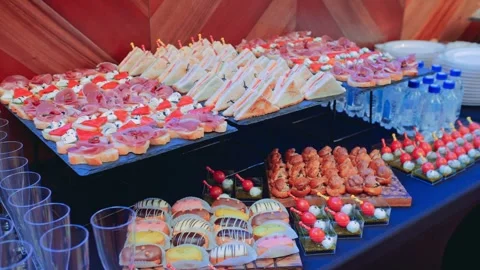 Elegant Buffet Spread with Canapés and Desserts Video stock 305399434