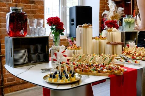 Elegant buffet table with assorted appetizers and beverages in modern setting Stock Photos