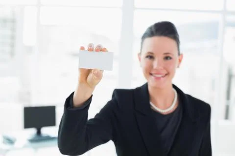 Elegant businesswoman holding a business card in office Stock Photos