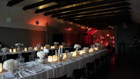 Elegant Candlelit Banquet Table Setting in Modern Event Venue Interior Stock Footage 337434990