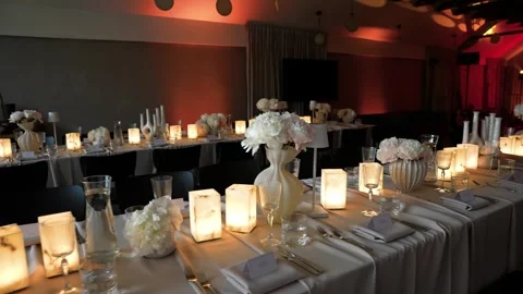 Elegant Candlelit Banquet Table Setting With White Florals for Special Event or Stock Footage 337435034