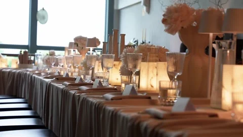 Elegant Candlelit Banquet Table Setting with Crystal Glassware and Floral Stock Footage 337435058