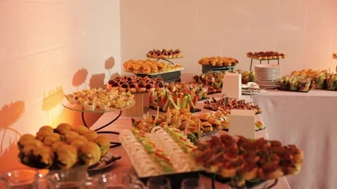 Elegant catering buffet table with assorted appetizers at formal event Stock Footage 324571802