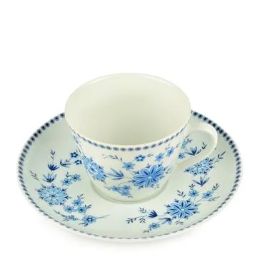 Elegant ceramic tea cup with a matching saucer featuring classic blue flora.. Stock Photos