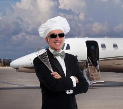 Elegant chef posing in front of a private jet Stock Photos