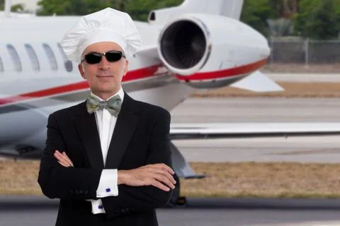 Elegant chef posing in front of a private jet Stock Photos