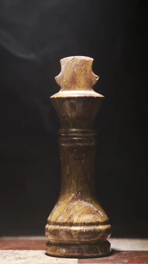 Elegant Chess Piece Surrounded by Dramatic Smoke on Dark Background Stock Footage 338142325