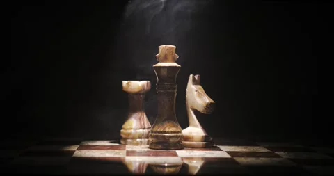 Elegant Chess Pieces Illuminated in Dramatic Lighting Stock Footage 338141348