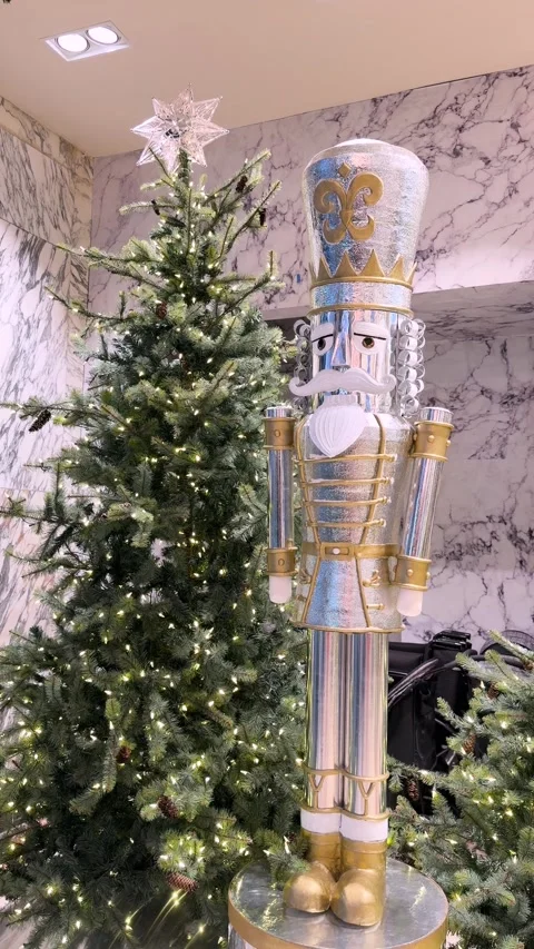 Elegant Christmas nutcracker soldier and decorated tree with glowing fairy Stock Footage 341435603