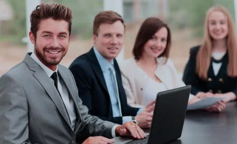 Elegant co-workers looking at camera during meeting in office Stock Photos