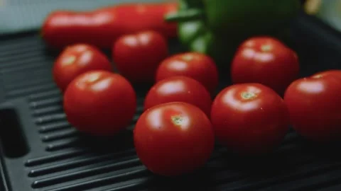 Elegant culinary view of glossy tomatoes developing grill marks Stock Footage 342152655