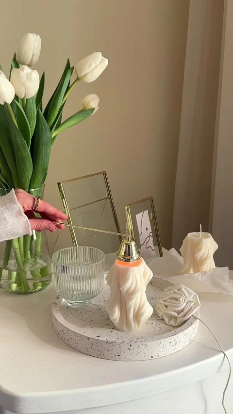 Elegant decorative display showcases soft candles and fresh tulips Stock Footage 340760176