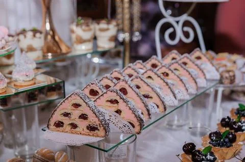 Elegant dessert table setting showcasing an array of pastries including cherr Stock Photos