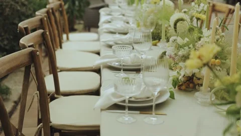 An Elegant Dining Setup Complete with Beautiful Floral Decoration for Special Stock Footage 306156680