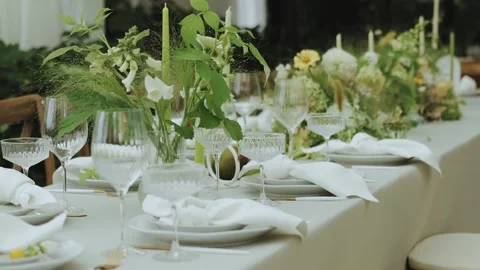 An elegant dining setup with exquisite floral arrangements and beautiful crystal Stock Footage 308397646