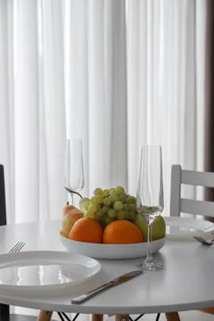 An Elegant Dining Setup Featuring a Fresh Fruit Arrangement for Enjoyment Stock Photos