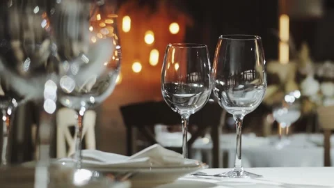 An Elegant Dining Table adorned with Fine Glassware in a Upscale Restaurant Stock Footage 306295010