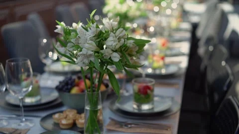An Elegant Dining Table Arrangement Featuring Beautiful Flowers and Fresh, Stock Footage 291006270