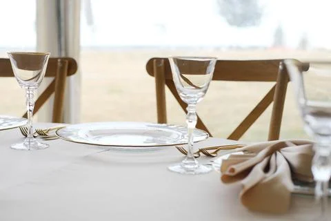 Elegant dining table set with fine china and crystal glassware, featuring a Stock Photos