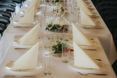 Elegant dining table set for a formal event with white tablecloth, folded n.. Stock Photos