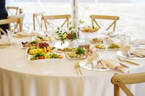 Elegant dining table set for a special event, featuring an array of gourmet Stock Photos