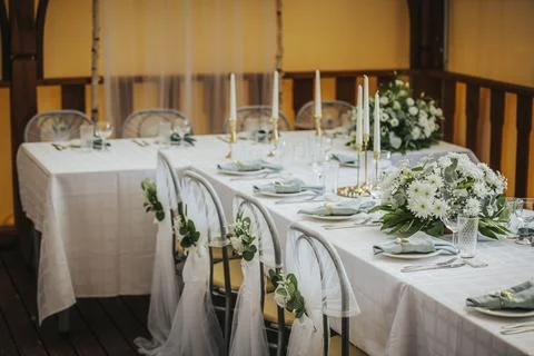Elegant dining table set for a special occasion with white tablecloth, flor.. Stock Photos