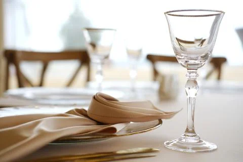 Elegant dining table setting featuring crystal glassware, fine china, and soft Stock Photos
