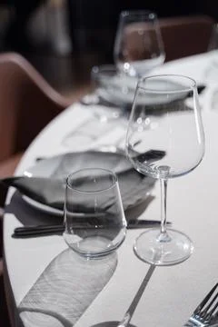 Elegant dining table setting with glassware, cutlery, and soft lighting  Stock Photos