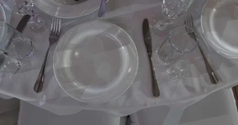 Elegant dining table setting with pristine plates, polished cutlery Stock Footage 316202371