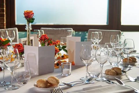 Elegant Dining Table Setting With Roses and Glassware in Soft Natural Light Stock Photos