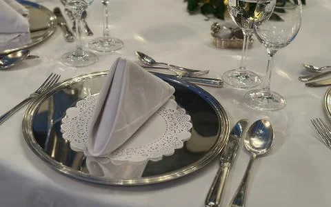 Elegant Dining Table Setting with Silverware, Crystal Glasses, and Folded N.. Stock Photos