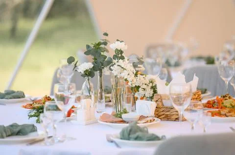 Elegant dining table setup with floral arrangements and gourmet dishes Stock Photos
