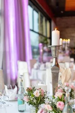Elegant dinner setup featuring flowers and candlelight in a beautifully Stock Photos
