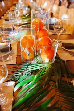 Elegant dinner setup with fruit and greenery for a special event Stock Photos
