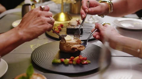 Elegant Dinner Table Scene With Hands Sharing Gourmet Dessert And Fruit Garnish Stock Footage 342286222
