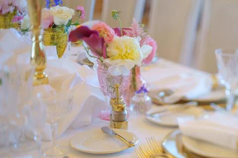 Elegant dinner table set with silverware, napkin and glass at restaurant befo Stock Photos
