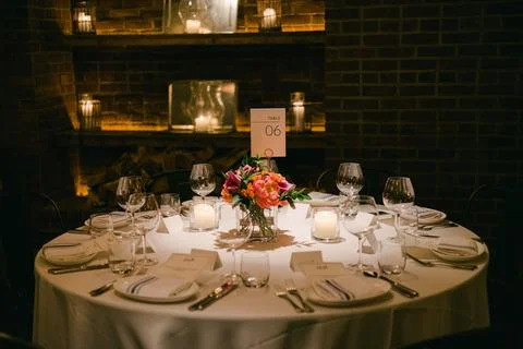 Elegant dinner table set for a special occasion in a cozy restaurant with soft Stock Photos