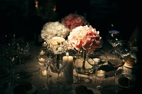 Elegant Dinner Table Setting with Flowers and Candles Stock Photos