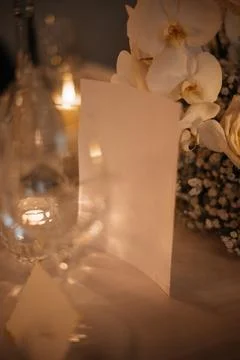 Elegant Dinner Table Setting with Menu and Flowers Stock Photos