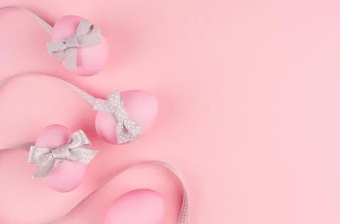 Elegant easter background - eggs with grey bow and wavy ribbons as border on  Stock Photos